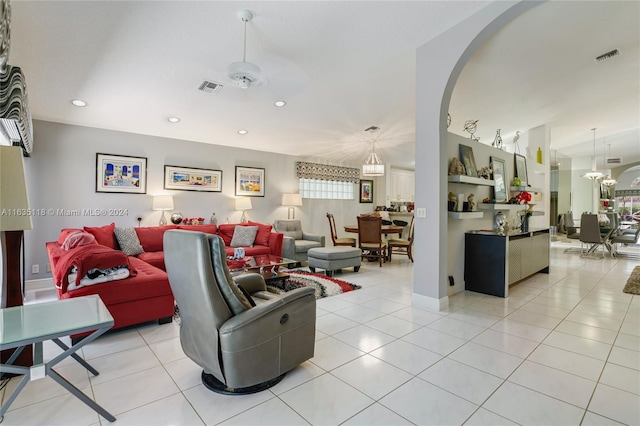 tiled living room featuring ceiling fan