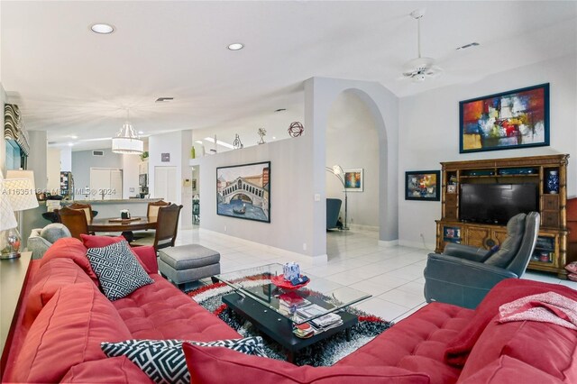 tiled living room with ceiling fan