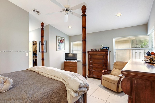 tiled bedroom featuring ceiling fan, a closet, a walk in closet, and lofted ceiling