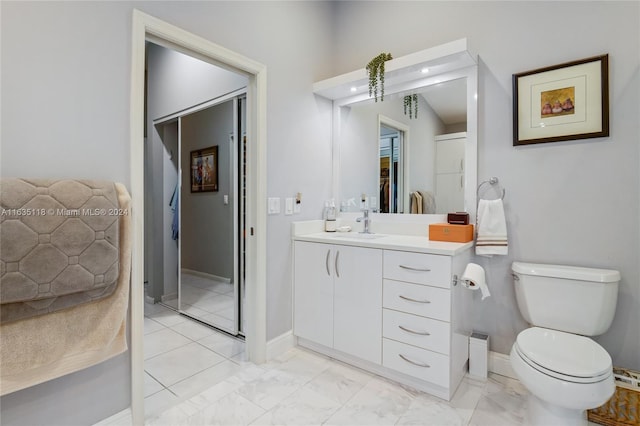 bathroom featuring tile patterned floors, vanity, and toilet