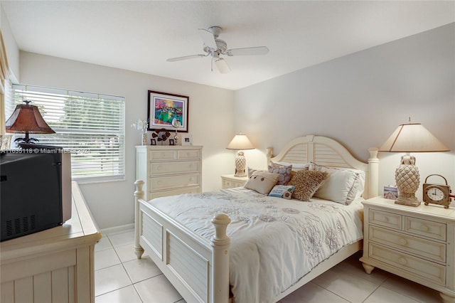 bedroom featuring ceiling fan, baseboards, and light tile patterned flooring