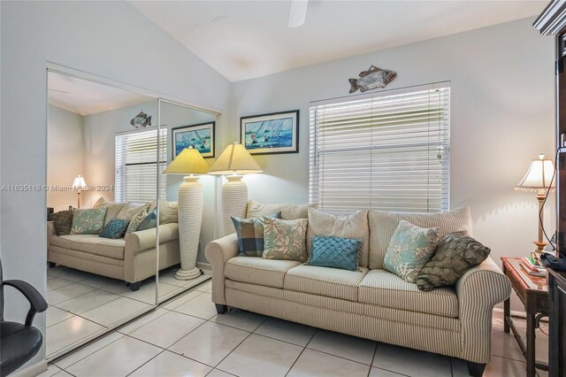 living room with light tile patterned floors and lofted ceiling