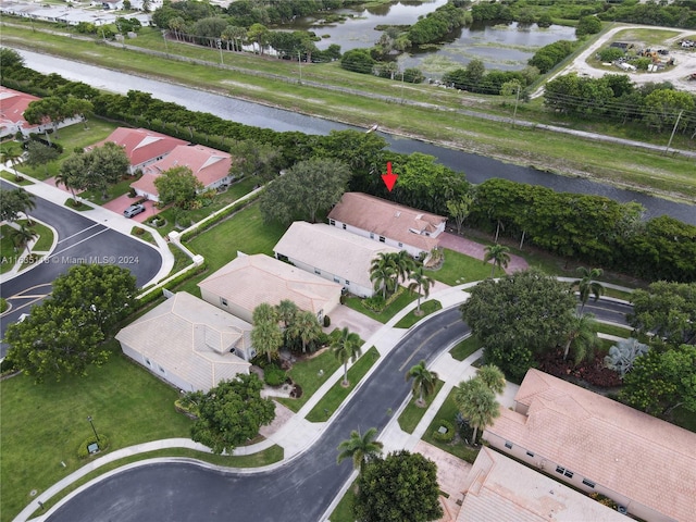 drone / aerial view featuring a water view and a residential view