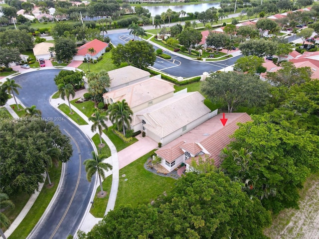 drone / aerial view featuring a water view and a residential view