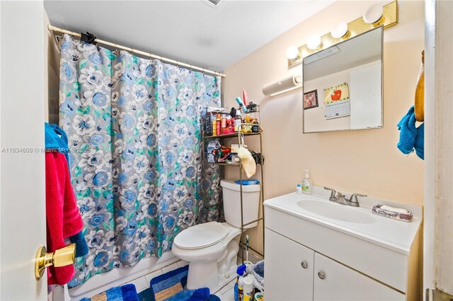 bathroom featuring a shower with shower curtain, vanity, toilet, and tile patterned flooring