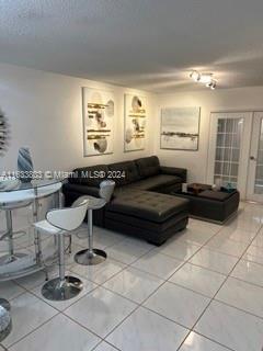 living room with tile patterned floors