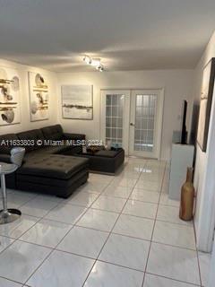 tiled living room with french doors