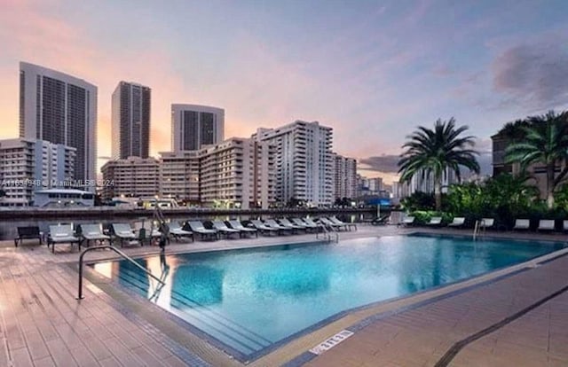 view of pool at dusk