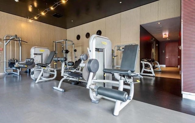 exercise room featuring wood walls