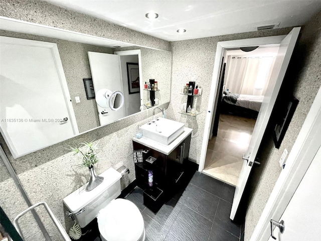 bathroom with vanity, tile patterned flooring, and toilet