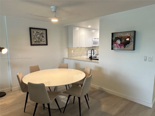 dining area featuring ceiling fan and light hardwood / wood-style flooring