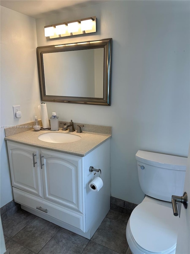 bathroom featuring vanity, toilet, and tile patterned floors