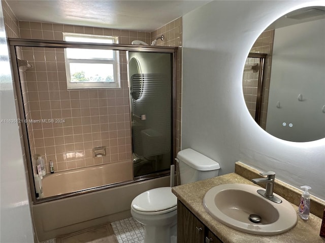 full bathroom featuring tile patterned flooring, toilet, enclosed tub / shower combo, and vanity