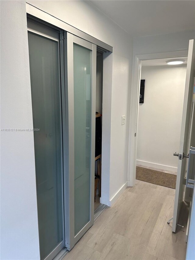 hallway with light wood-type flooring