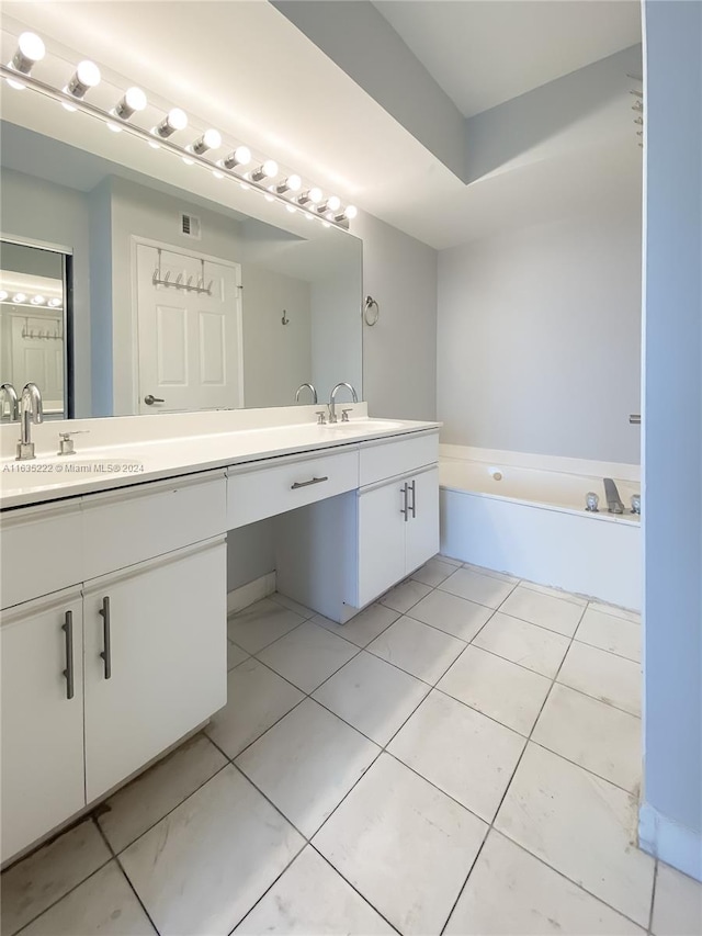 bathroom featuring dual vanity, a washtub, and tile patterned floors