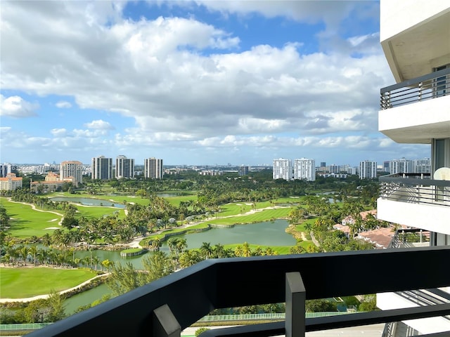 balcony with view of golf course, a view of city, and a water view