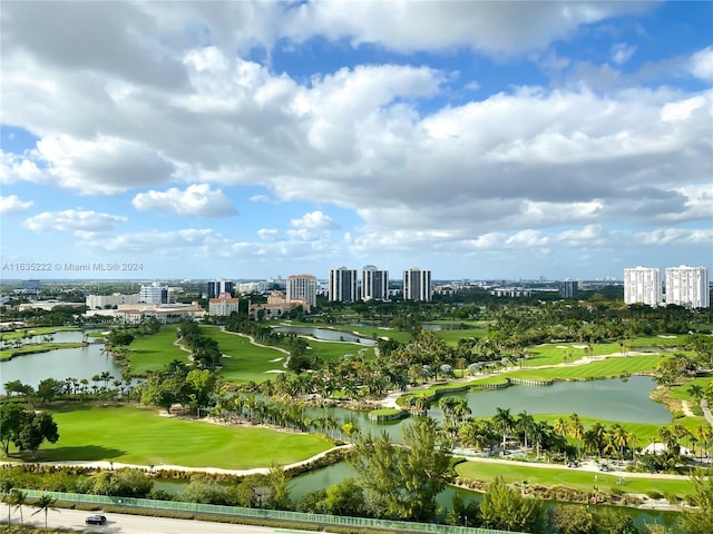 birds eye view of property featuring golf course view, a city view, and a water view