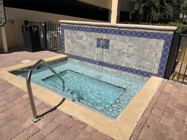 view of swimming pool featuring a community hot tub