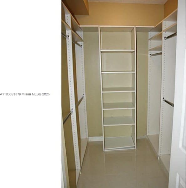 spacious closet featuring light tile patterned floors