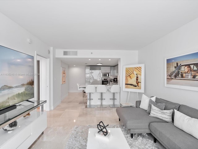 living area with visible vents and marble finish floor