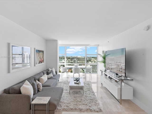 tiled living room featuring a wall of windows