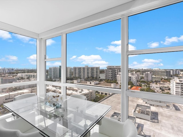 sunroom / solarium with a view of city and a wall of windows