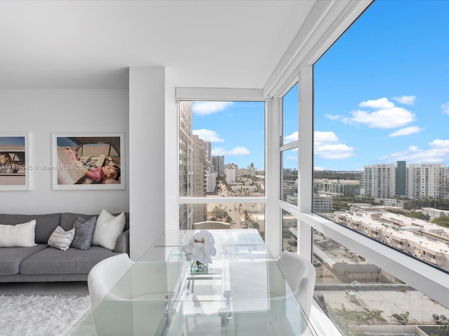 sunroom / solarium featuring a city view
