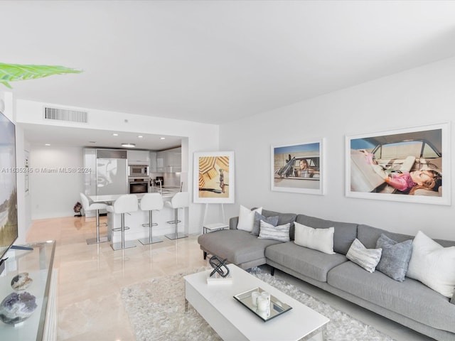living room featuring visible vents and marble finish floor