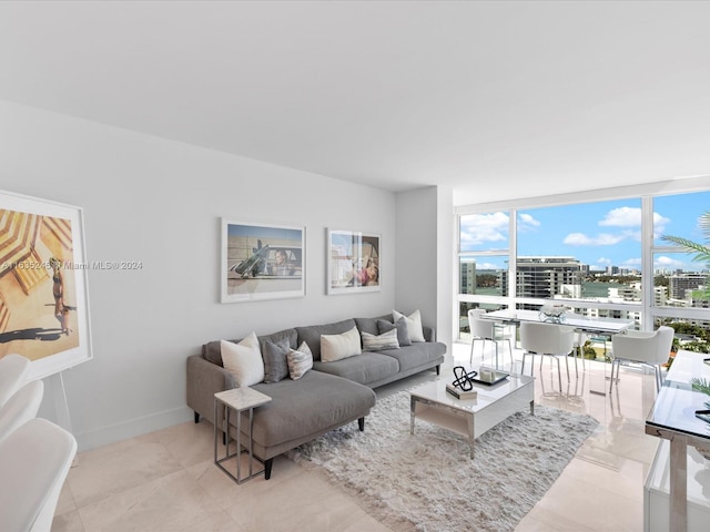 tiled living area with floor to ceiling windows and baseboards