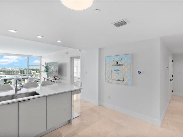 kitchen featuring light tile patterned flooring and sink