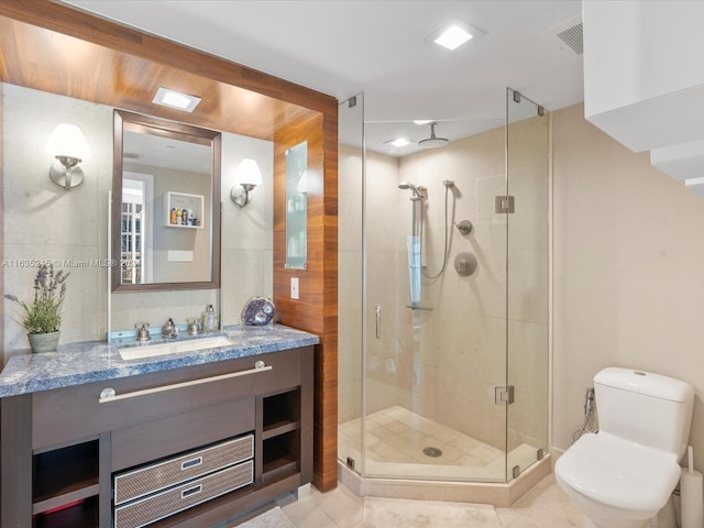 bathroom featuring a shower stall, visible vents, toilet, vanity, and tile patterned flooring