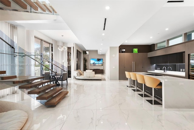 kitchen with sink, pendant lighting, and a kitchen breakfast bar