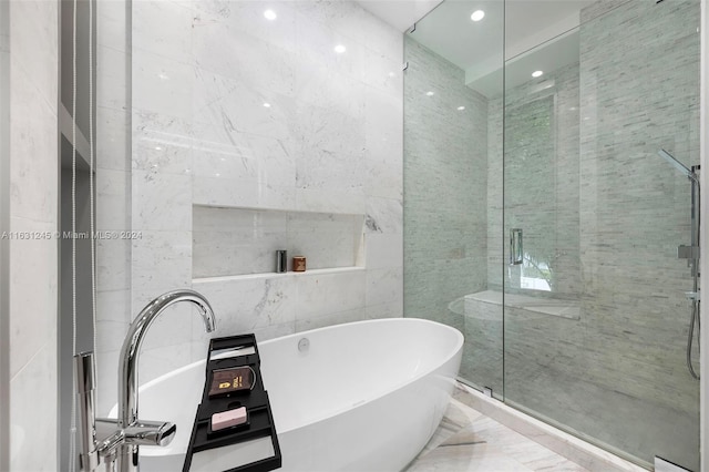 bathroom with independent shower and bath and tile walls