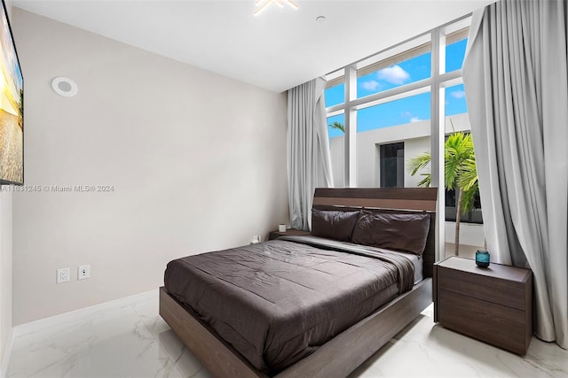 bedroom featuring floor to ceiling windows