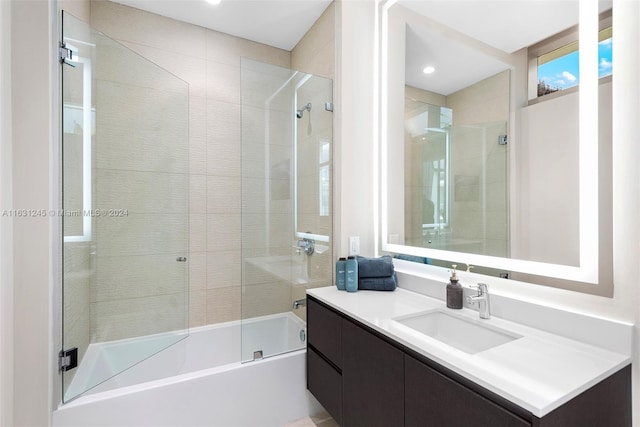 bathroom featuring vanity and bath / shower combo with glass door