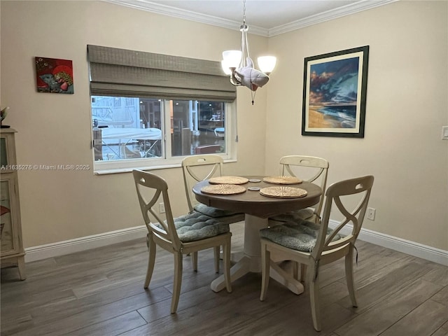 dining area with ornamental molding, dark hardwood / wood-style floors, and a notable chandelier