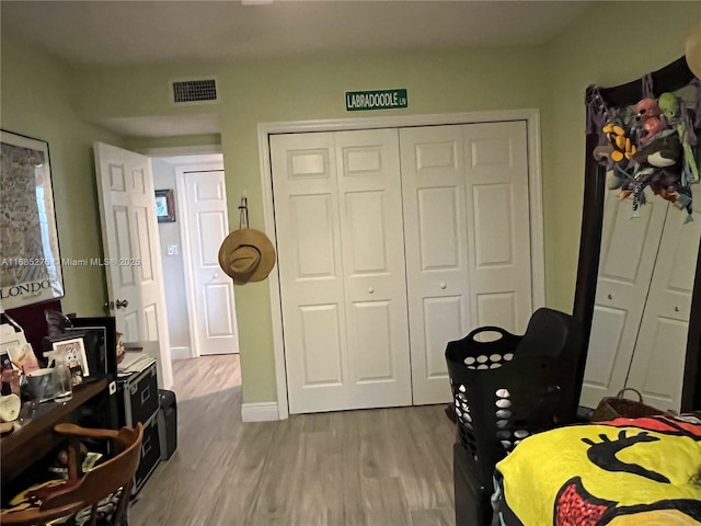 bedroom featuring light wood-type flooring and a closet