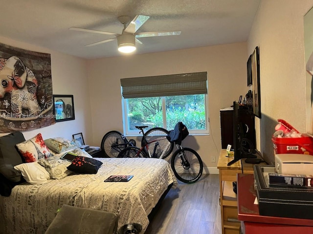 bedroom featuring ceiling fan and hardwood / wood-style floors