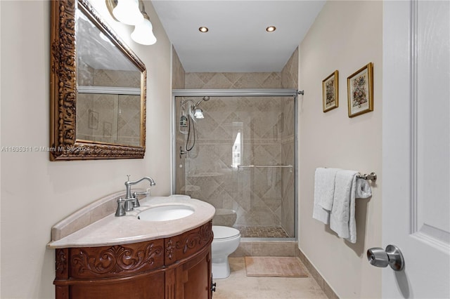 bathroom featuring tile patterned floors, vanity, an enclosed shower, and toilet