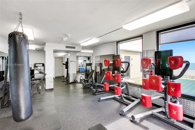 gym with a textured ceiling