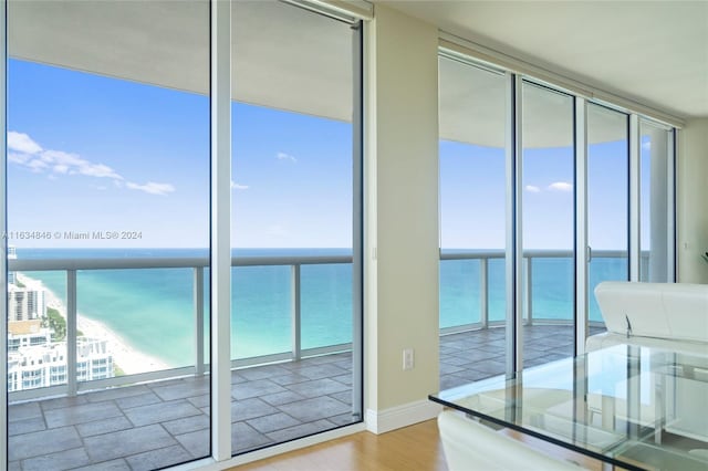 interior space with a water view and a beach view