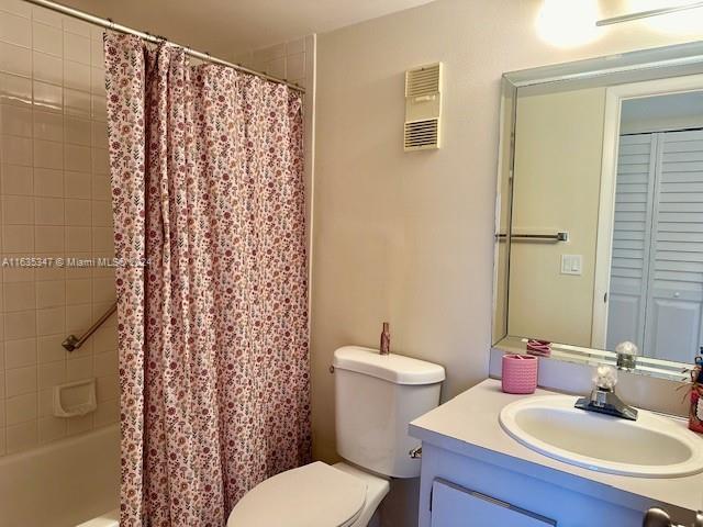 full bathroom with vanity, shower / bath combination with curtain, and toilet