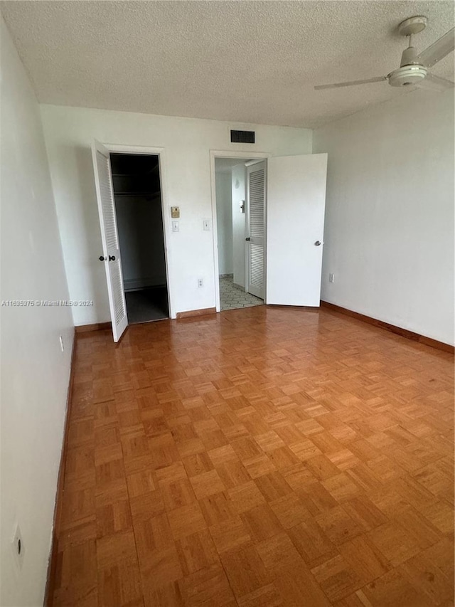 unfurnished bedroom featuring a closet, ceiling fan, and a textured ceiling