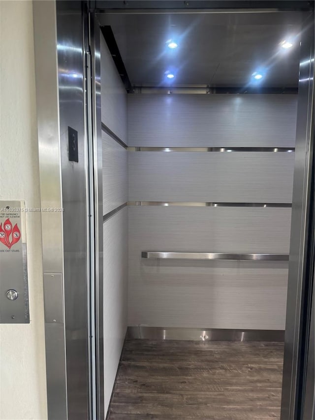 room details with elevator and wood-type flooring