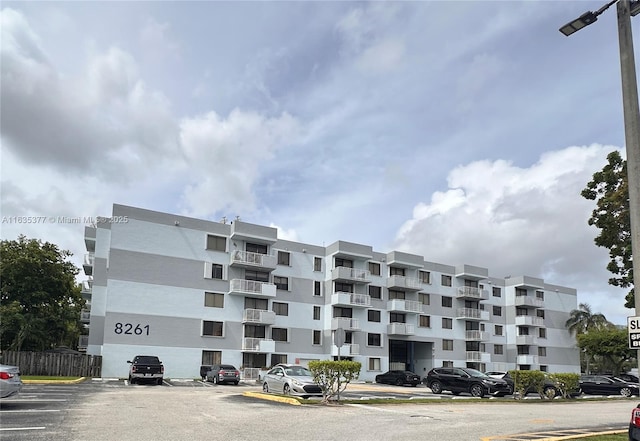 view of building exterior featuring uncovered parking