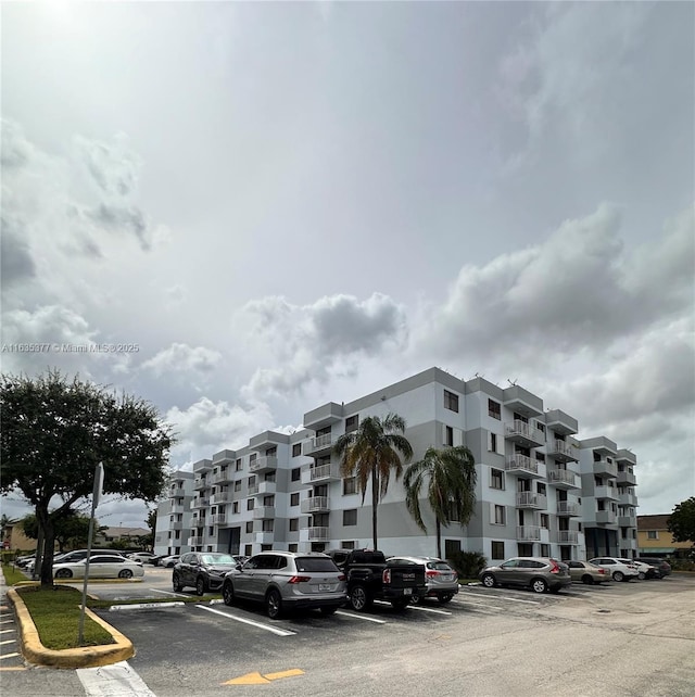 view of building exterior with uncovered parking