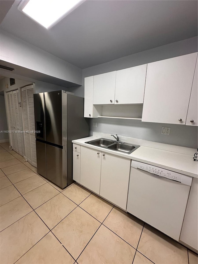 kitchen with stainless steel refrigerator with ice dispenser, light countertops, white cabinetry, white dishwasher, and a sink