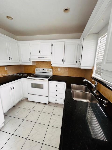 kitchen with white cabinets, white range with electric stovetop, and sink