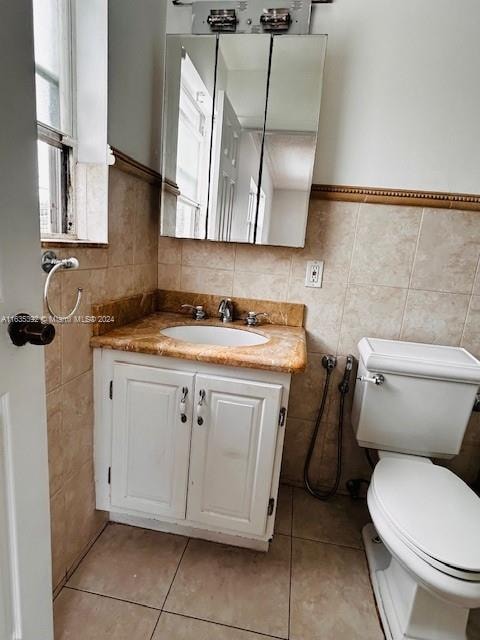 bathroom featuring tile walls, tile patterned flooring, vanity, and toilet