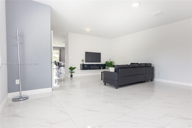 living area featuring recessed lighting, baseboards, and marble finish floor